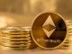 Picture of ethereum coins staked together with one coin stood next to them